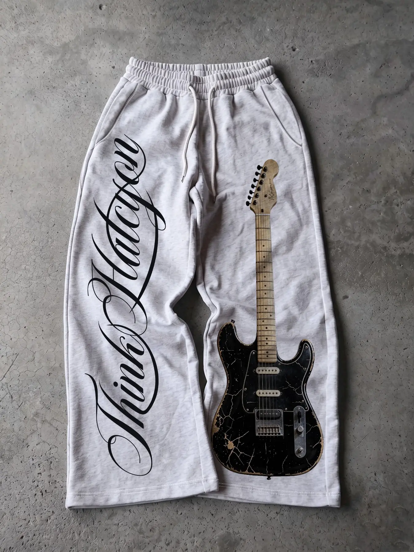 Y2K-era punk rock wide-leg sweatpants, Casual street sweatpants, in light gray with a worn vintage electric guitar and handwritten print, elastic drawstring waistband, perfect for skateboarding, everyday wear, alternative hip-hop casual statement pants