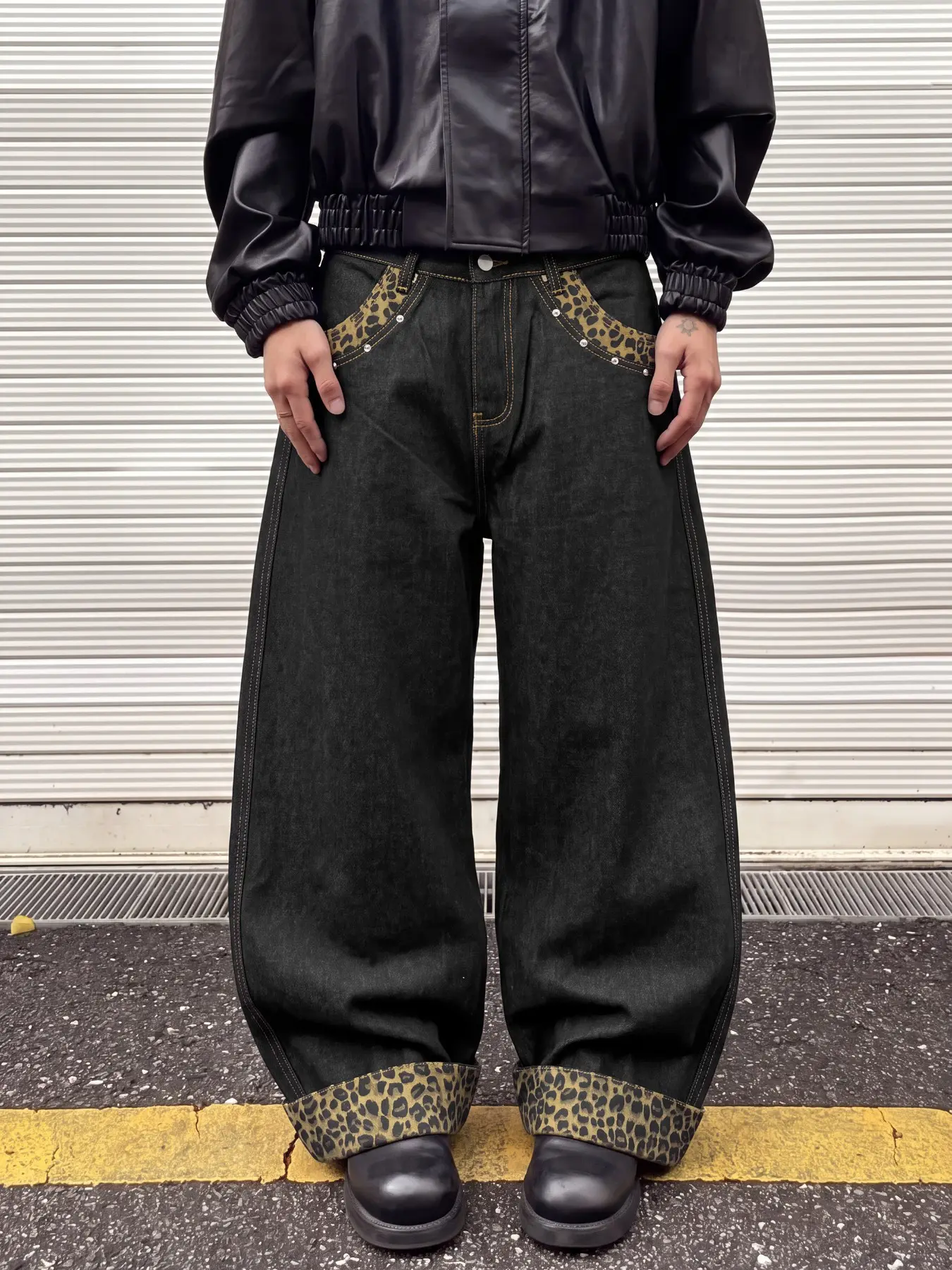 Men's straight leg wide leg loose denim jeans, black washed leopard print patchwork with rolled edges and pocket rivets embellished, suitable for music festival party outfits