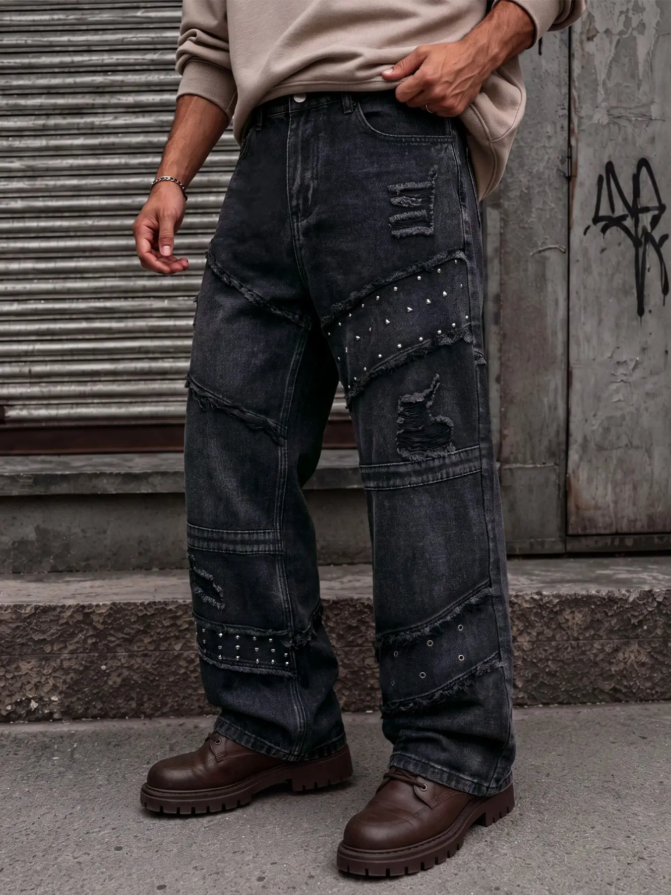 Men's black loose wide-leg denim pants, featuring multi-layer patchwork distressed design and rivet embellishment details, creating an American vintage streetwear look Jeans