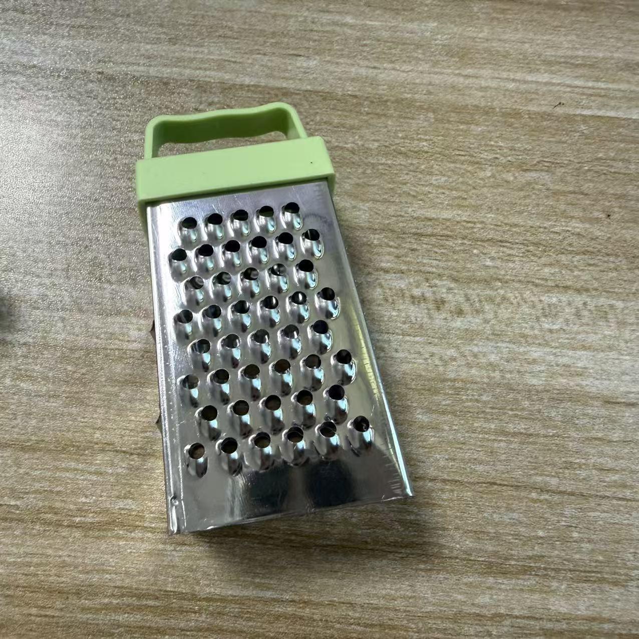 Multifunctional stainless steel household tool for peeling garlic, slicing vegetables and fruits, and shredding potatoes