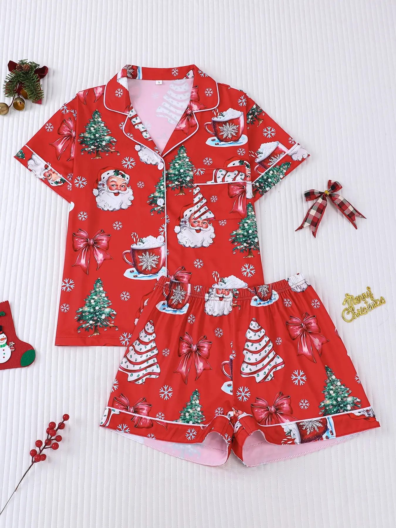 Women's 2-piece Christmas pajama set, red base with Santa, Christmas trees, bows and hot cocoa prints. Classic cozy festive style with white contrast trim. Lapel short sleeve top with pocket, elastic waist shorts, soft all-season loungewear