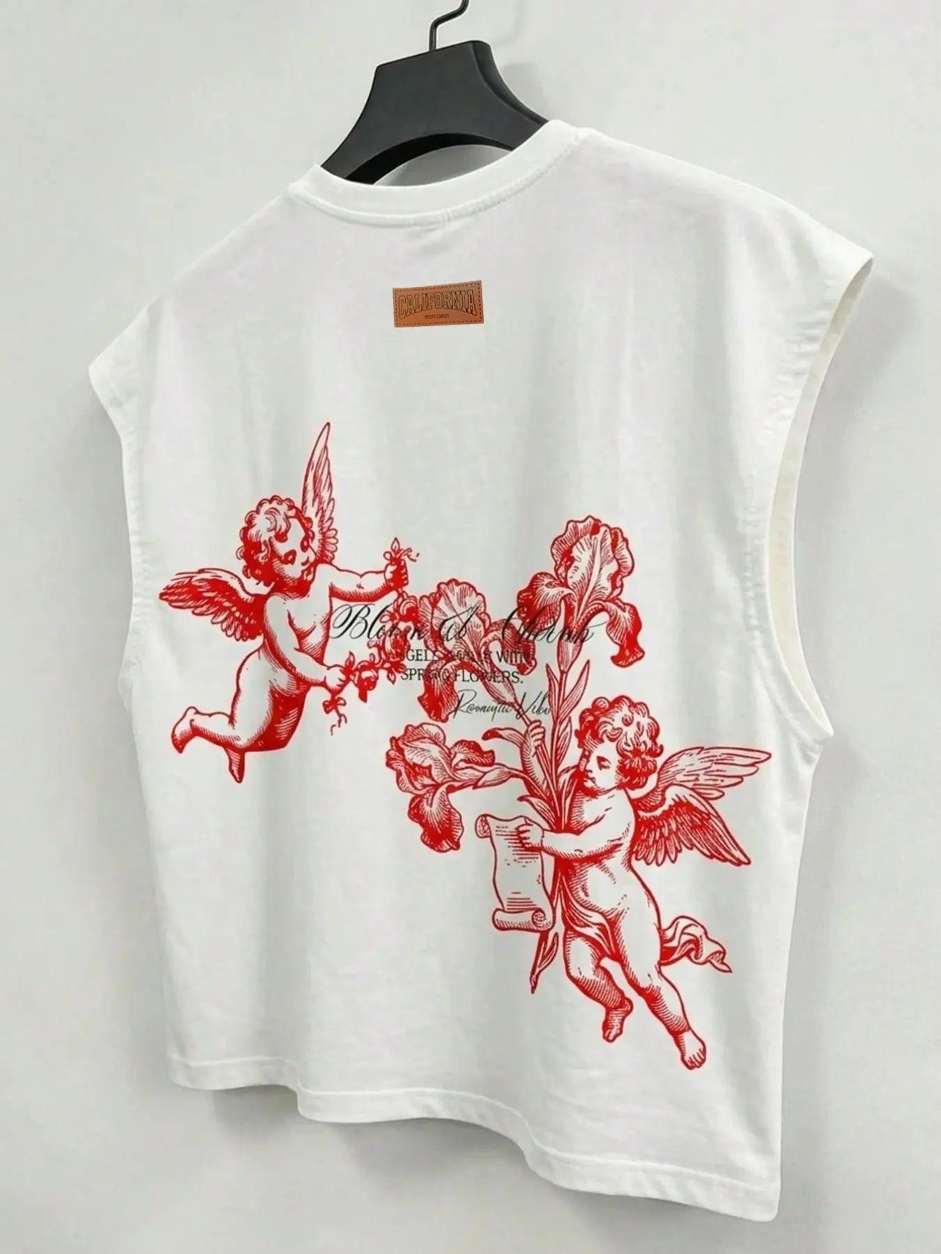 Men's sleeveless top featuring a cropped, broad-shoulder fit and a playful angel graphic accented with leather-effect details; a versatile basic suitable for layering or wearing on its own.