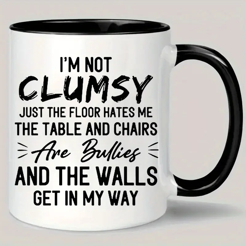 Humorous Coffee Mug Featuring The Phrase "I'M Not Clumsy" with a Black Interior And White Exterior, Perfect As a Sarcastic Gift for Both Men And Women. It Should Be Hand Washed Only And Carries a Bully-Free Message