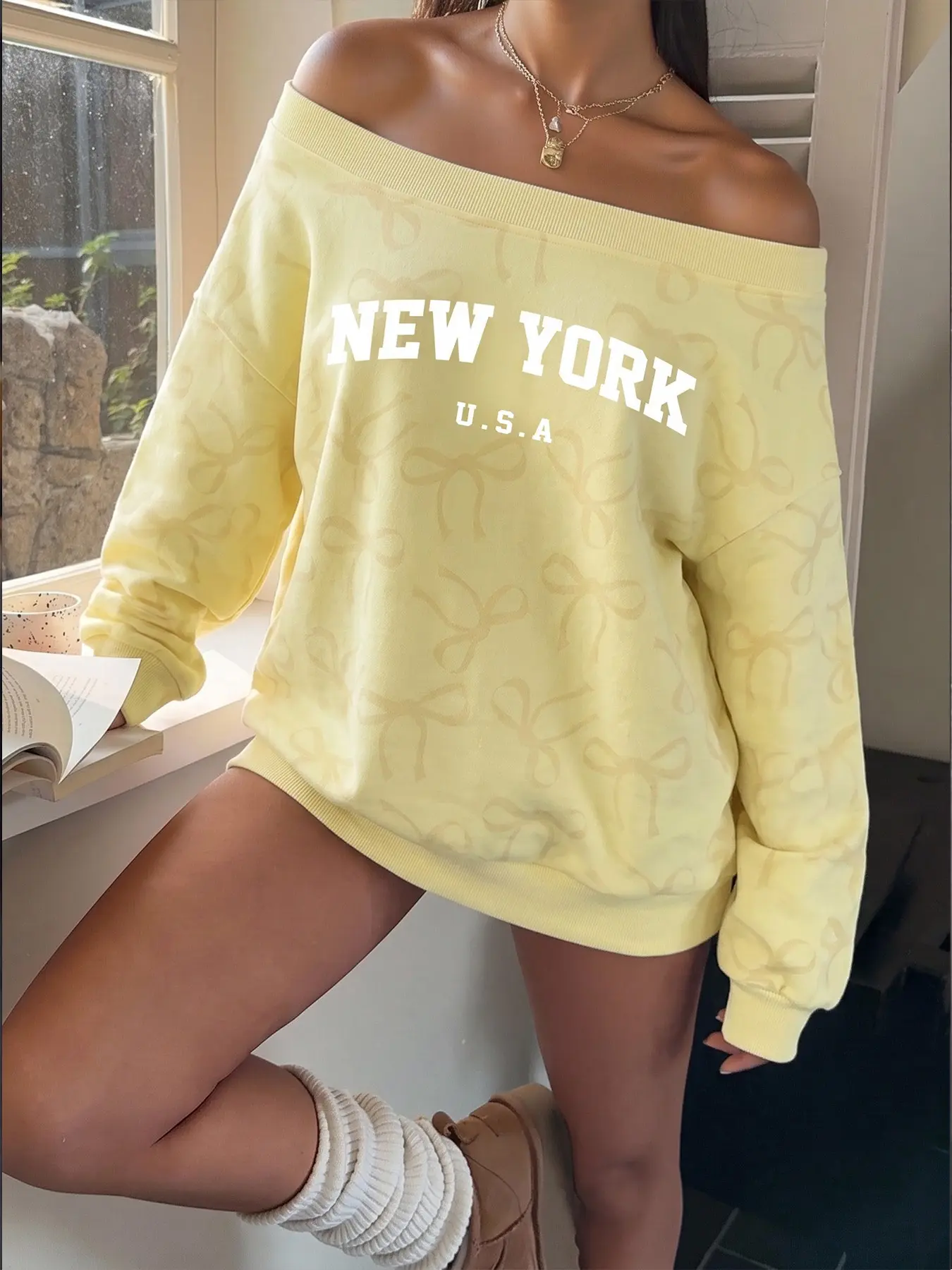 Women Pastel Pale Yellow Tone On Tone All Over Bow Print Oversized Sweatshirt Soft Lightweight Fleece Wide Boat Off Shoulder Drop Shoulder Long Sleeve Pullover Bold White NEW YORK U.S.A Letter Graphic Lazy Loose Fit Casual Top For Spring Autumn Cafe Daily