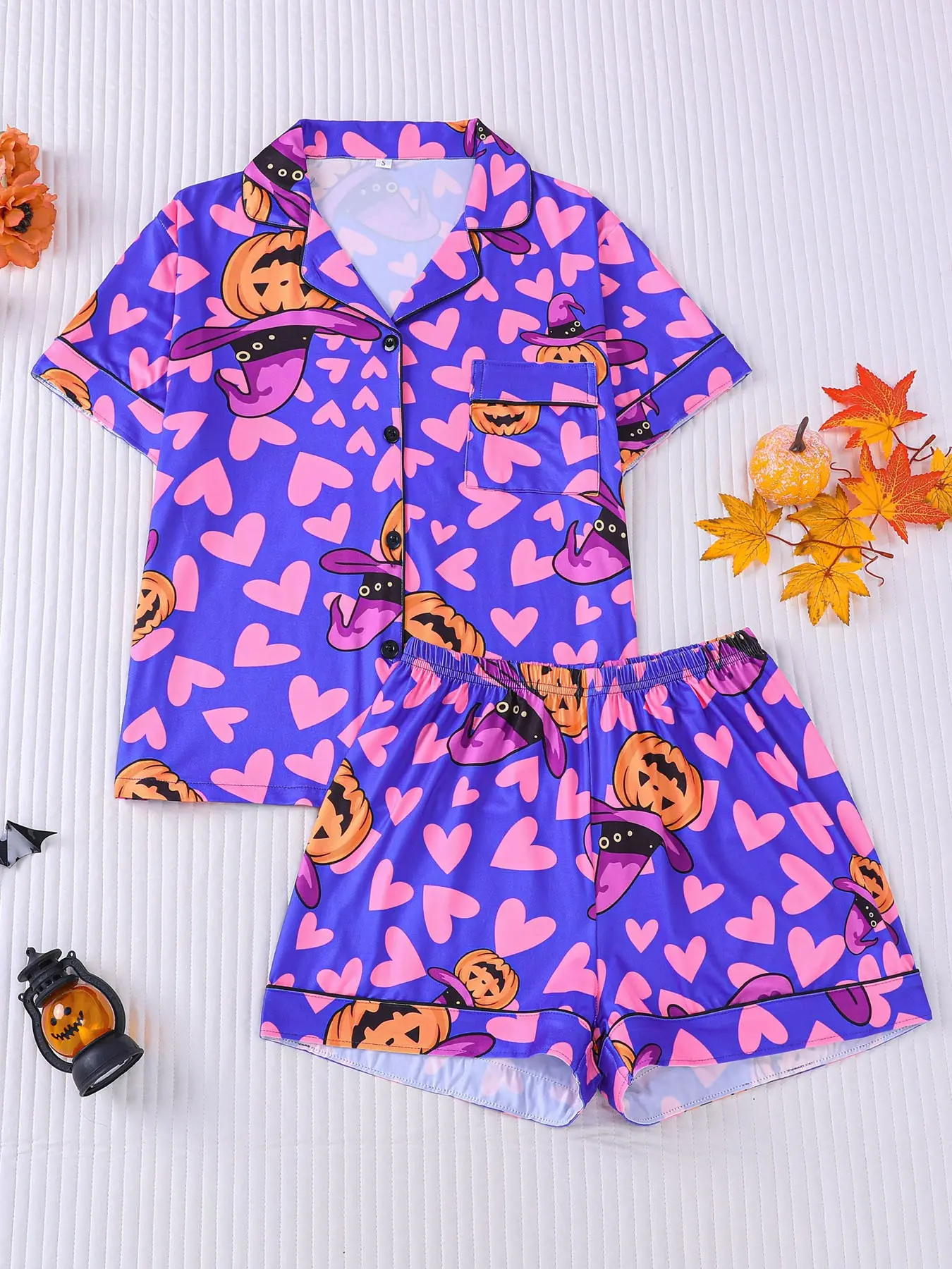 Women's 2-piece Halloween pajama set, deep purple base with pink hearts and witch hat pumpkin prints, sweet cool girly style. Black piping lapel top with pocket, elastic waist shorts, soft comfy year-round casual loungewear for women