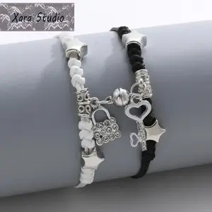 2Pcs Magnetic ECG Couple Bracelet Set, Black & White Woven Hand Rope with Love Heart Magnet. Adjustable handmade wristbands for lovers, featuring electrocardiogram design. Perfect couple jewelry gift for Valentine's Day, anniversaries and daily wear.