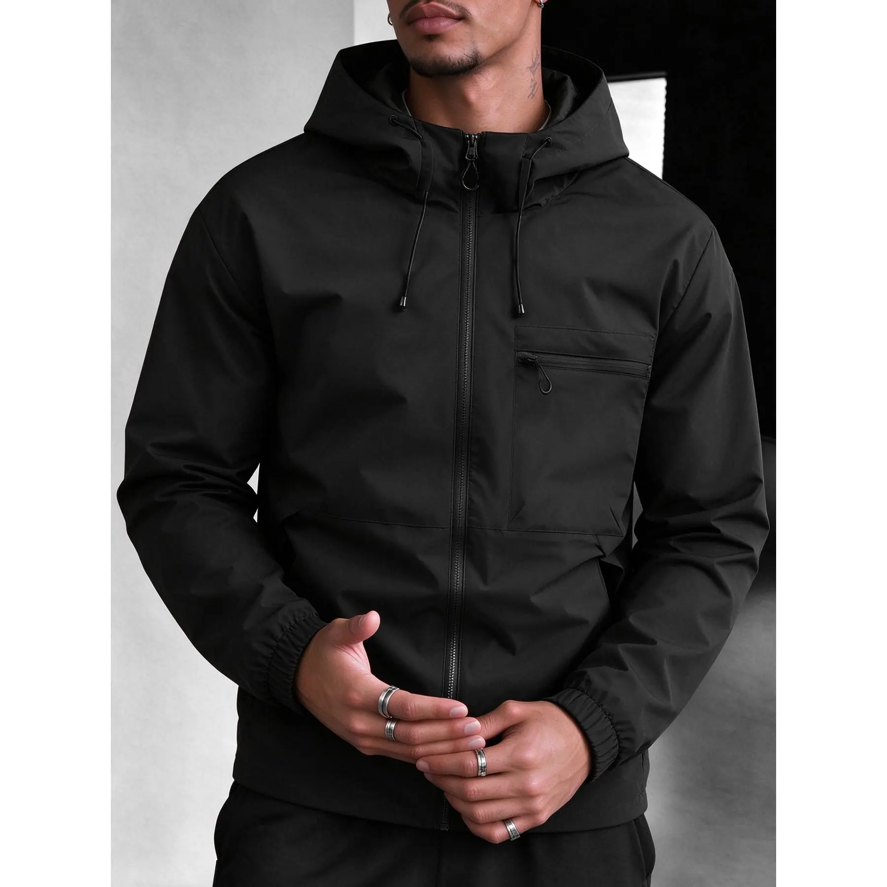 Men's fashionable hooded trendy coat, featuring a fully zipped closure design. The adjustable drawstring on the hood ensures a flexible and snug fit. Multiple zipped pockets for easy storage of items during hiking and daily outdoor activities.