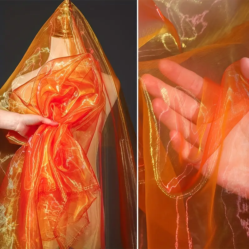 Orange shimmering sheer fabric, lightweight and breathable mesh material, suitable for DIY crafts, apparel, and wedding decorations