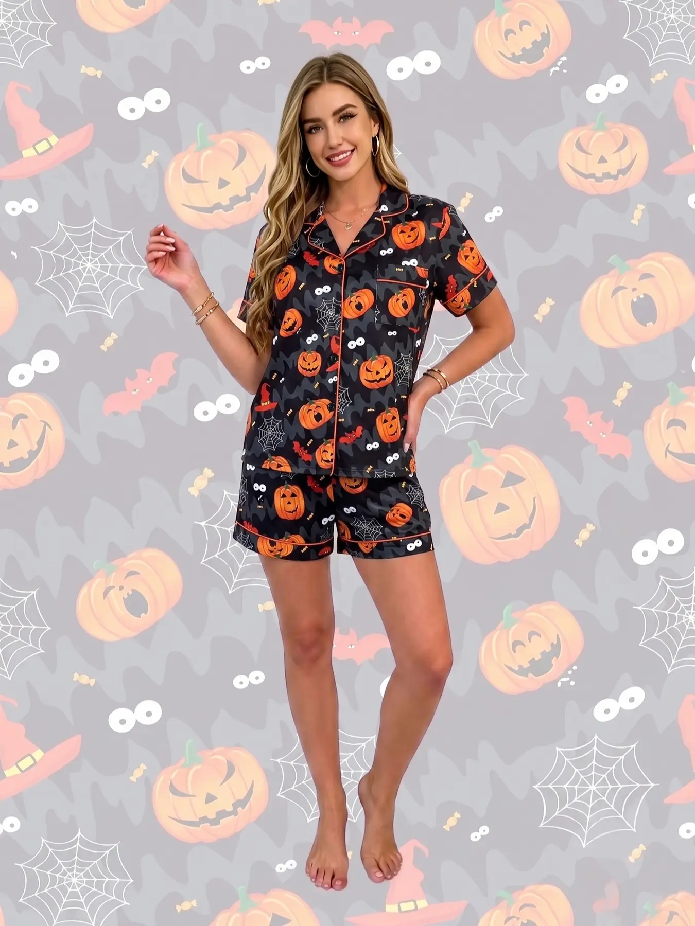 Women's 2-piece pajama set, black base with Halloween pumpkin prints. Jack-o'-lanterns, spider webs, bats and witch hats. Retro dark holiday style. Orange trim, lapel top with pocket, elastic waist shorts, soft comfy all-season loungewear