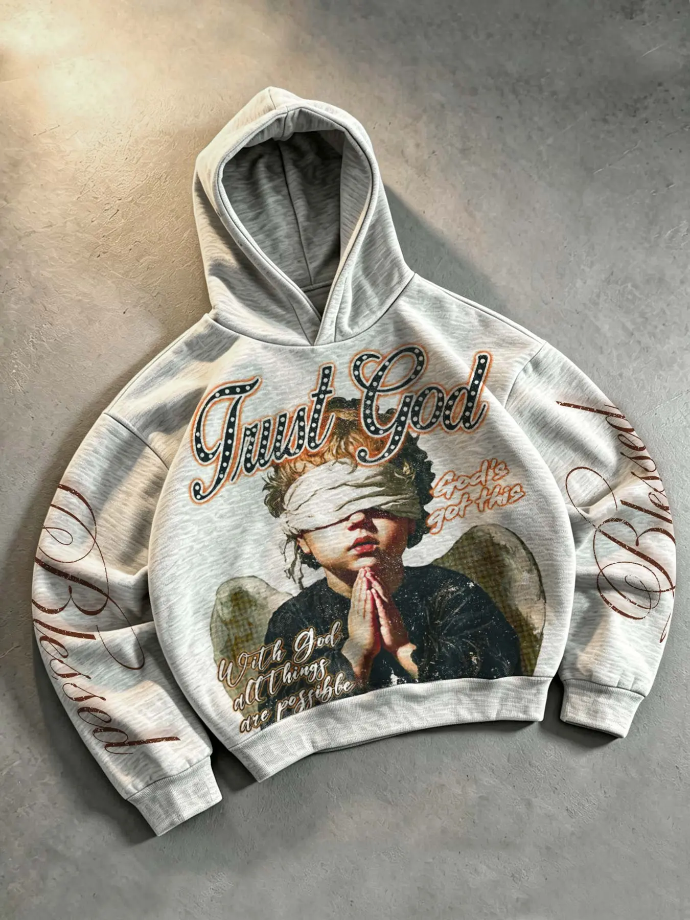 American vintage style distressed blindfolded prayer angel print men's pullover hoodie, featuring the slogan "Trust God," double sleeves with floral lettering design, loose fit, drop shoulders, trendy and versatile streetwear style, unisex.