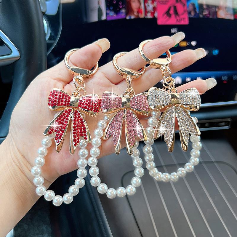 Rhinestone Bow Keychain with Pearl Wrist Strap, Luxury Bling Bow Car Key Ring, Elegant Metal Bag Charm Accessory for Women