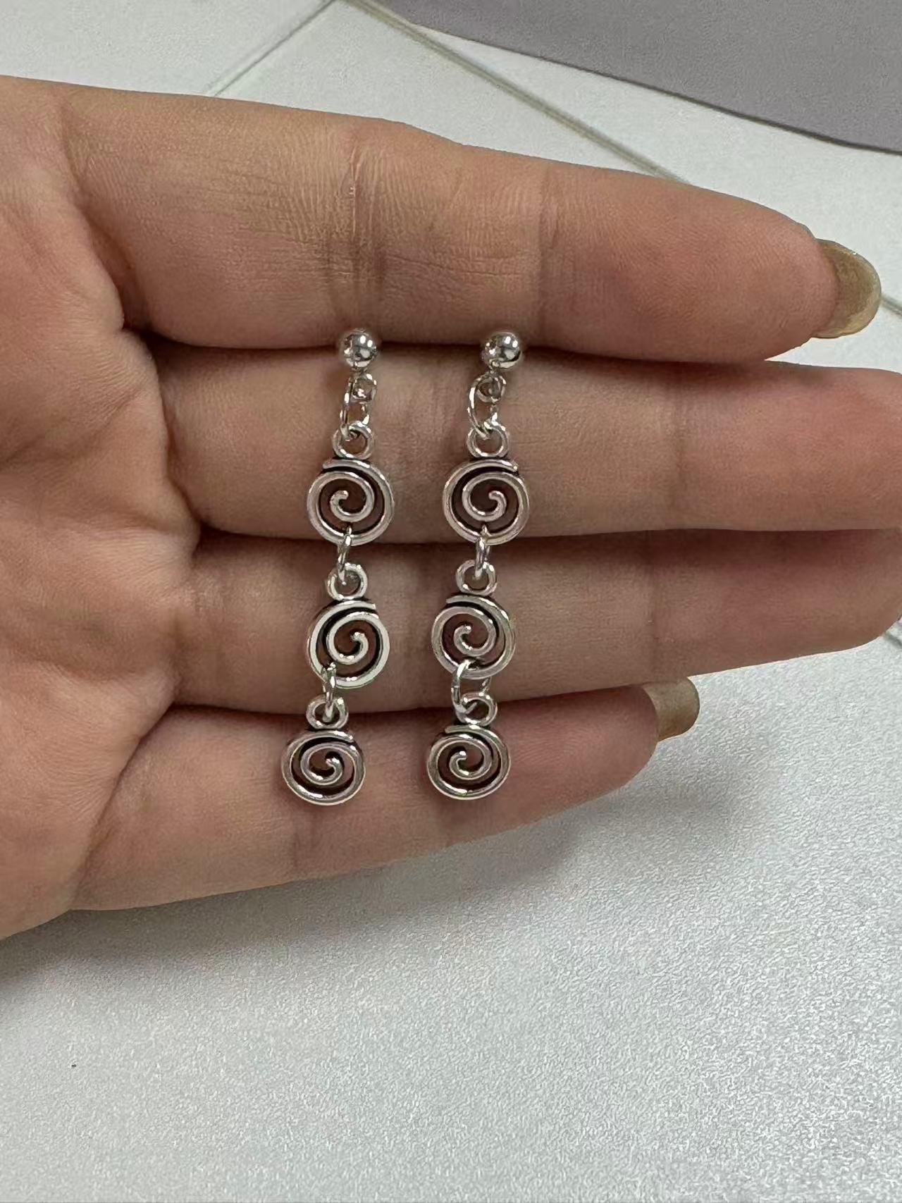 Vintage spiral earrings with distressed design, mosquito incense holder pendant, swirling long fringed earrings