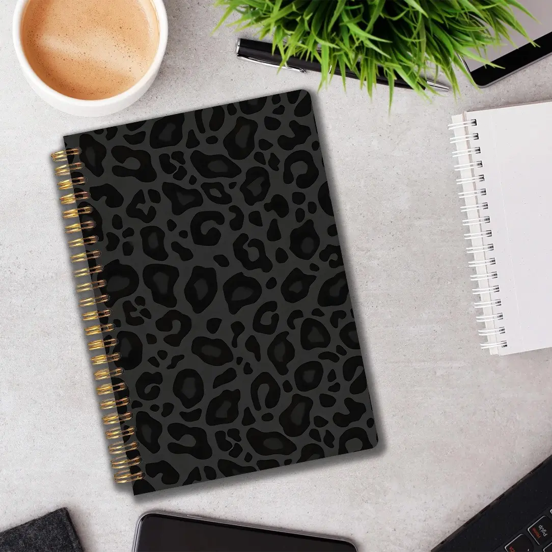 A stylish spiral-bound notebook featuring a leopard print pattern, A5 size, perfect as a gift for school, work, or home use, highlighting a black leopard print design.