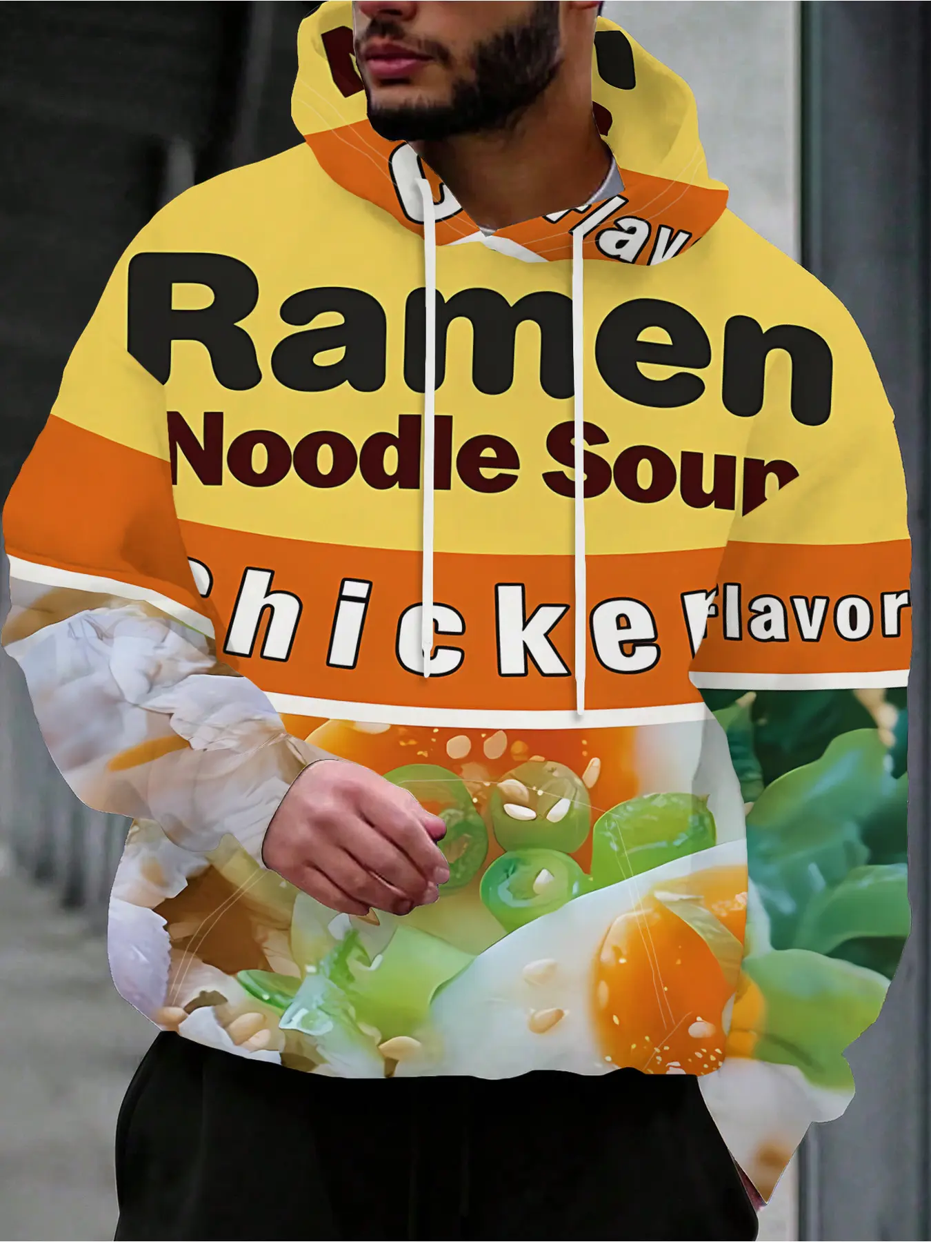 A Man Is Wearing A Hoodie Featuring The Words 'Ramen Noodle Soup' Along With Some Food Graphics