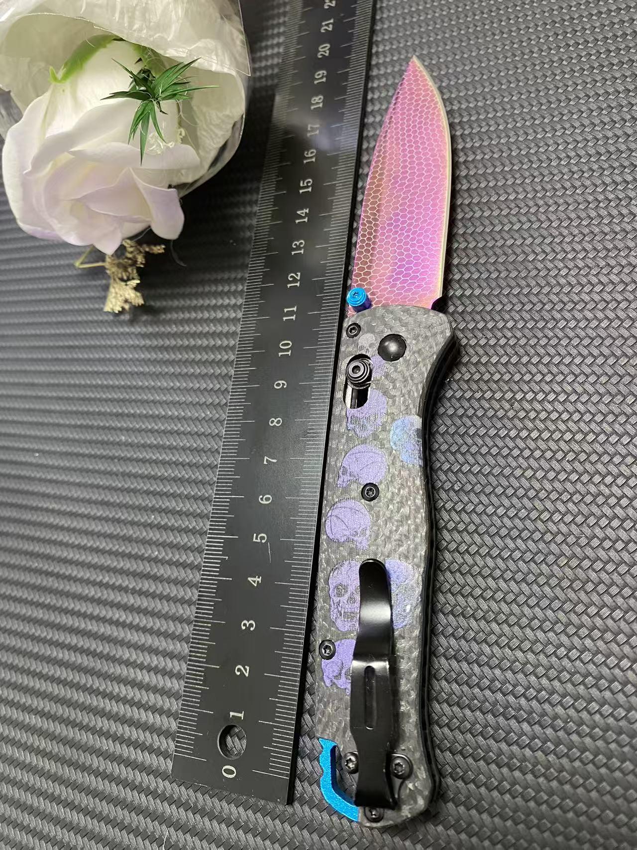 535 Outdoor Multi-Tool, carbon-fused handle, 3D-printed skull texture, laser-etched patterns with vibrant hues, vacuum-coated to achieve a titanium-like purplish-red finish, made of high-hardness Damascus steel
