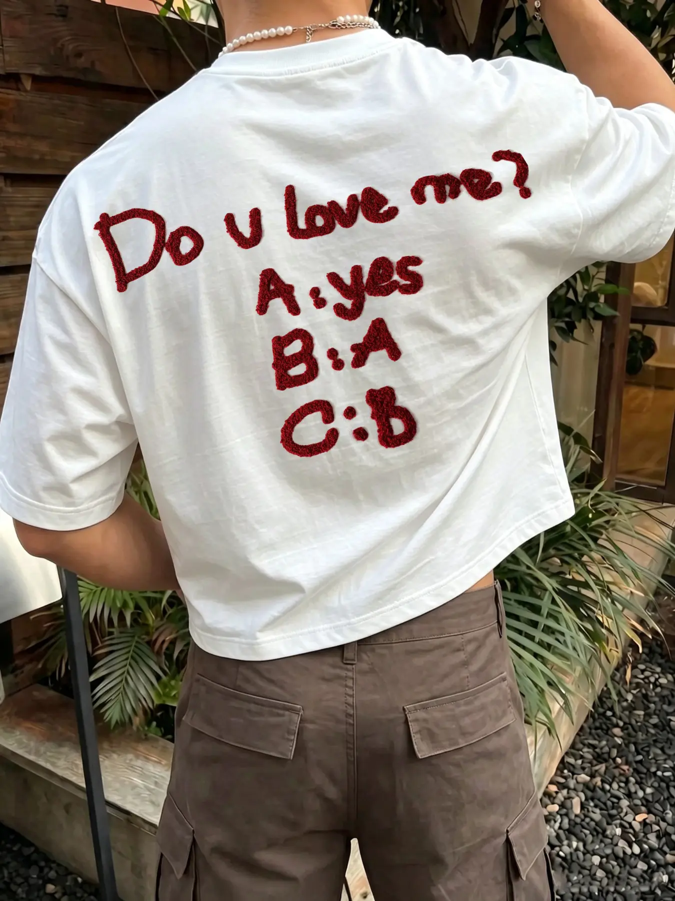Men's stylish Loose cropped white T-shirt featuring a playful "Do U Love Me?" slogan print with a fuzzy texture; a casual short-sleeve menswear piece perfect for romantic streetwear street-style looks and everyday wear.