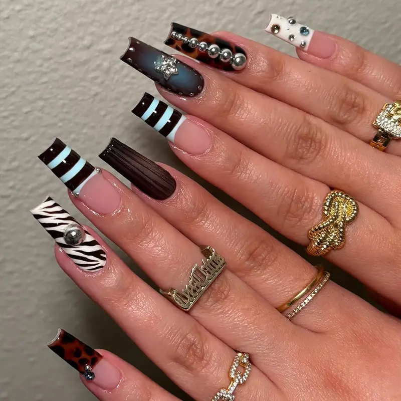 Edgy Zebra, Leopard Print Press On Nails, Decorative Nails for Women. Featuring 3D Metallic Stars, Silver Half Sphere Studs, and Dazzling Rhinestones on a Bold French Tip Base The Ultimate Must Have Fake Nails for Coachella and Cool Girl Style