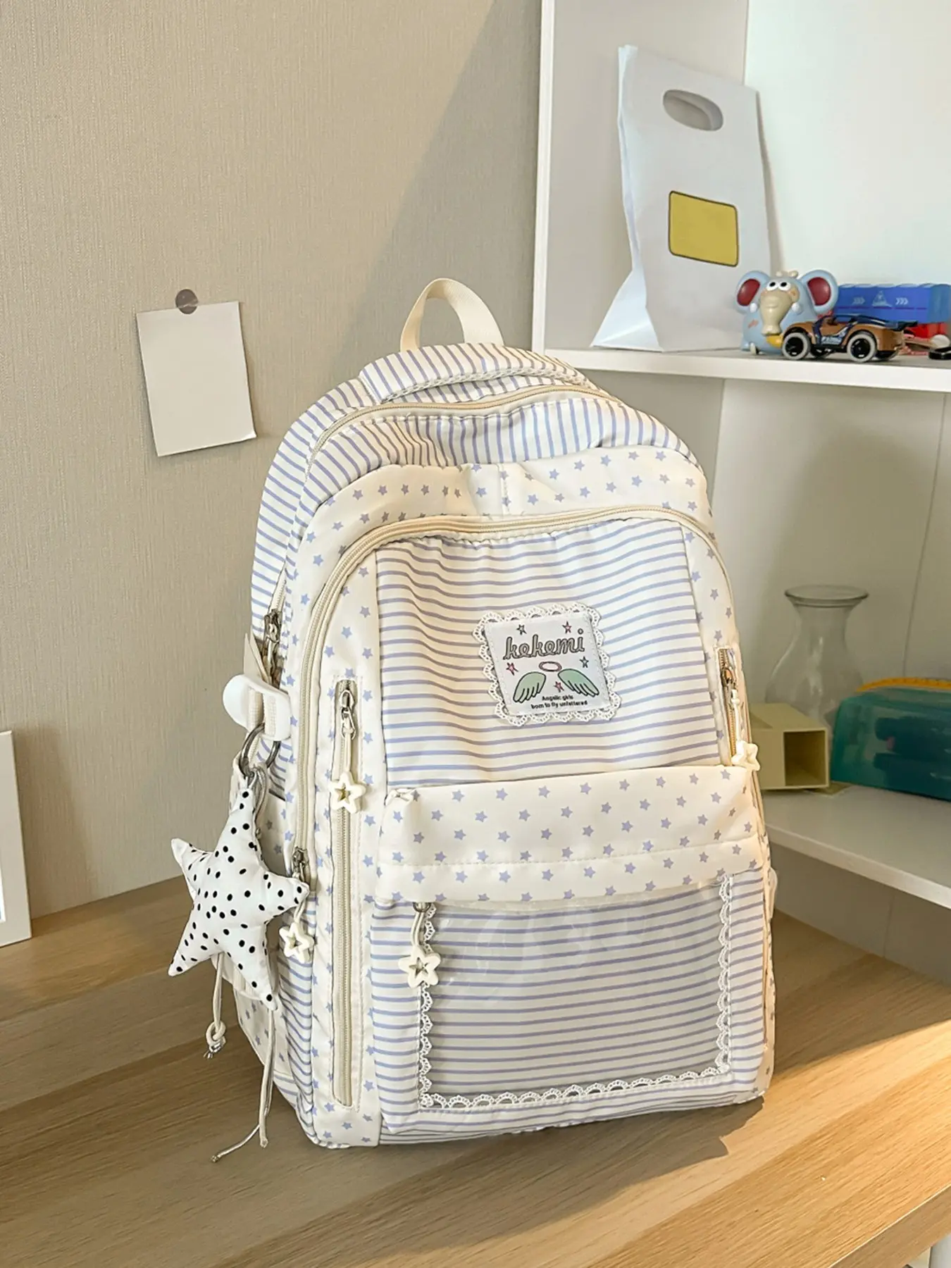 Gentle and fresh style fashionable high-value Casual Printed backpack with pentagram and striped print decoration, pentagram pendant design, large capacity multi compartment versatile backpack, suitable for campus classes