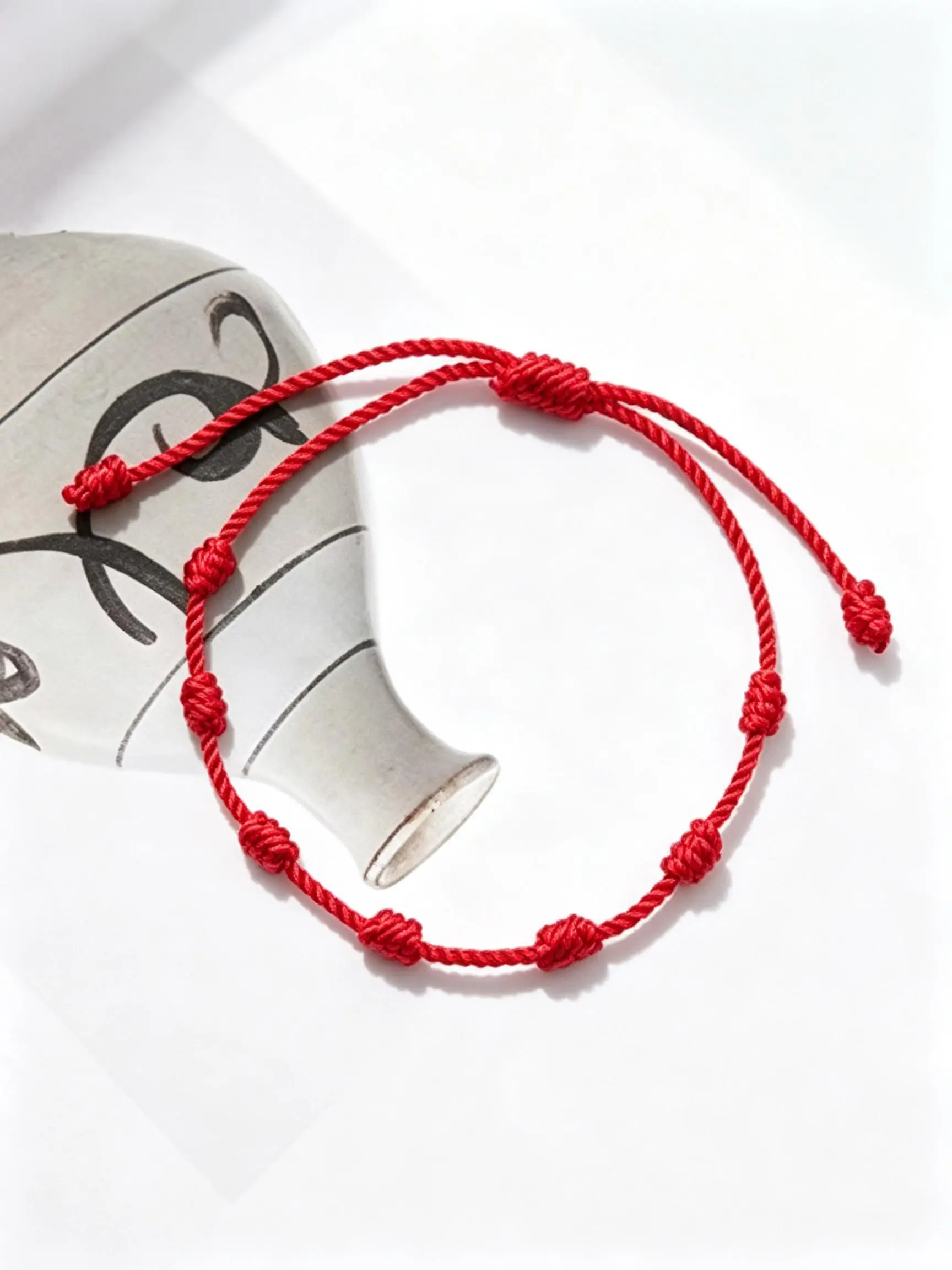 Adjustable Hand‑Knotted Red String Bracelet for Women and Men, made of polyester, Elegant Jewelry Bracelet, simple seven‑knot lucky wish bracelet, minimalist thin cord for daily wear, sweet blessing jewelry gift for teens, friends and family