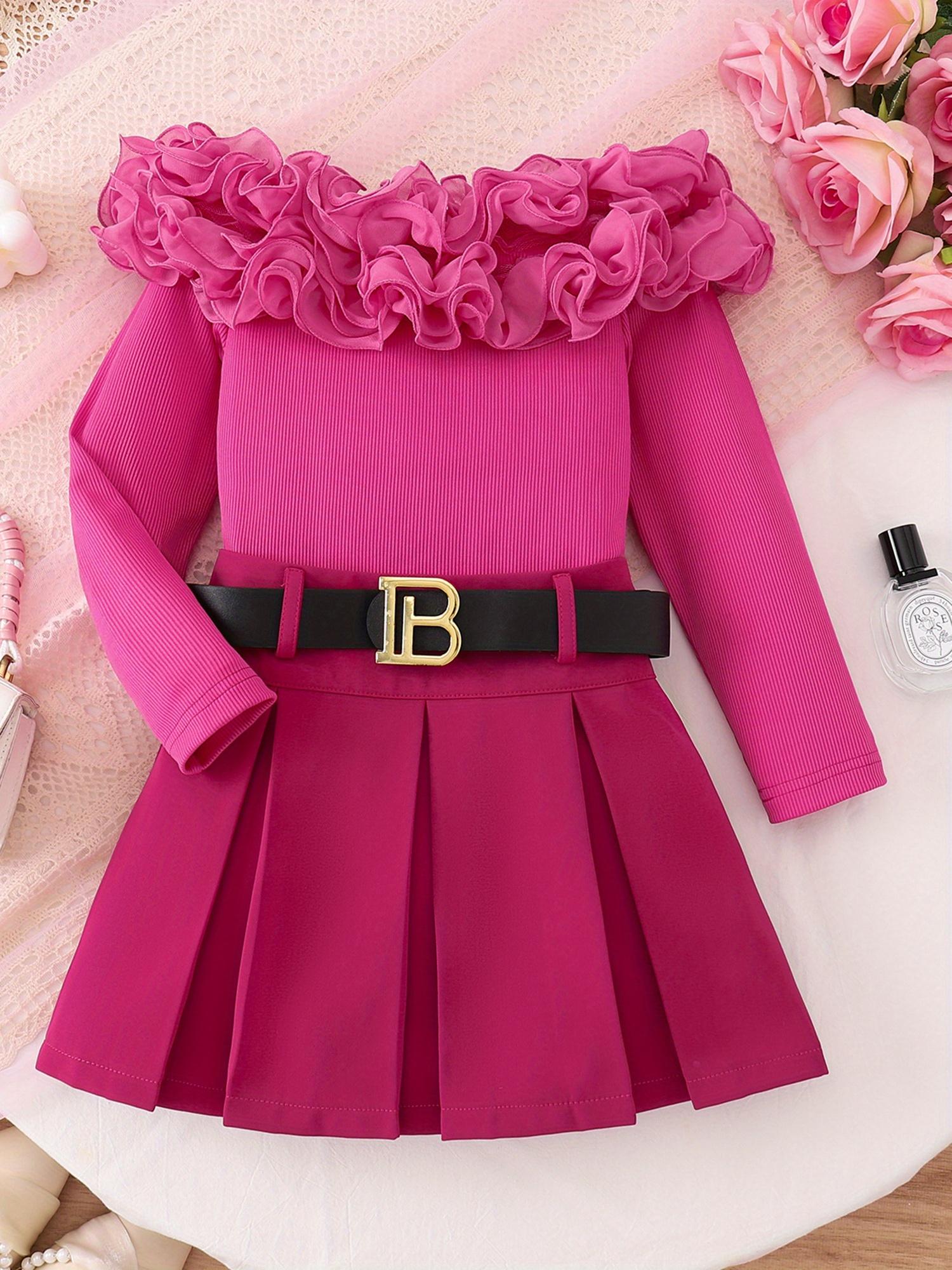 Girls' Dress, The Main Body Is Rose Red, The Shoulders Are Decorated with Flower-Like Folds, And The Long-Sleeved Design. with a Black Belt, There Are Golden Letters in The Middle of The Belt, And The Skirt Is Pleated. The Overall Style Is Sweet And Fa