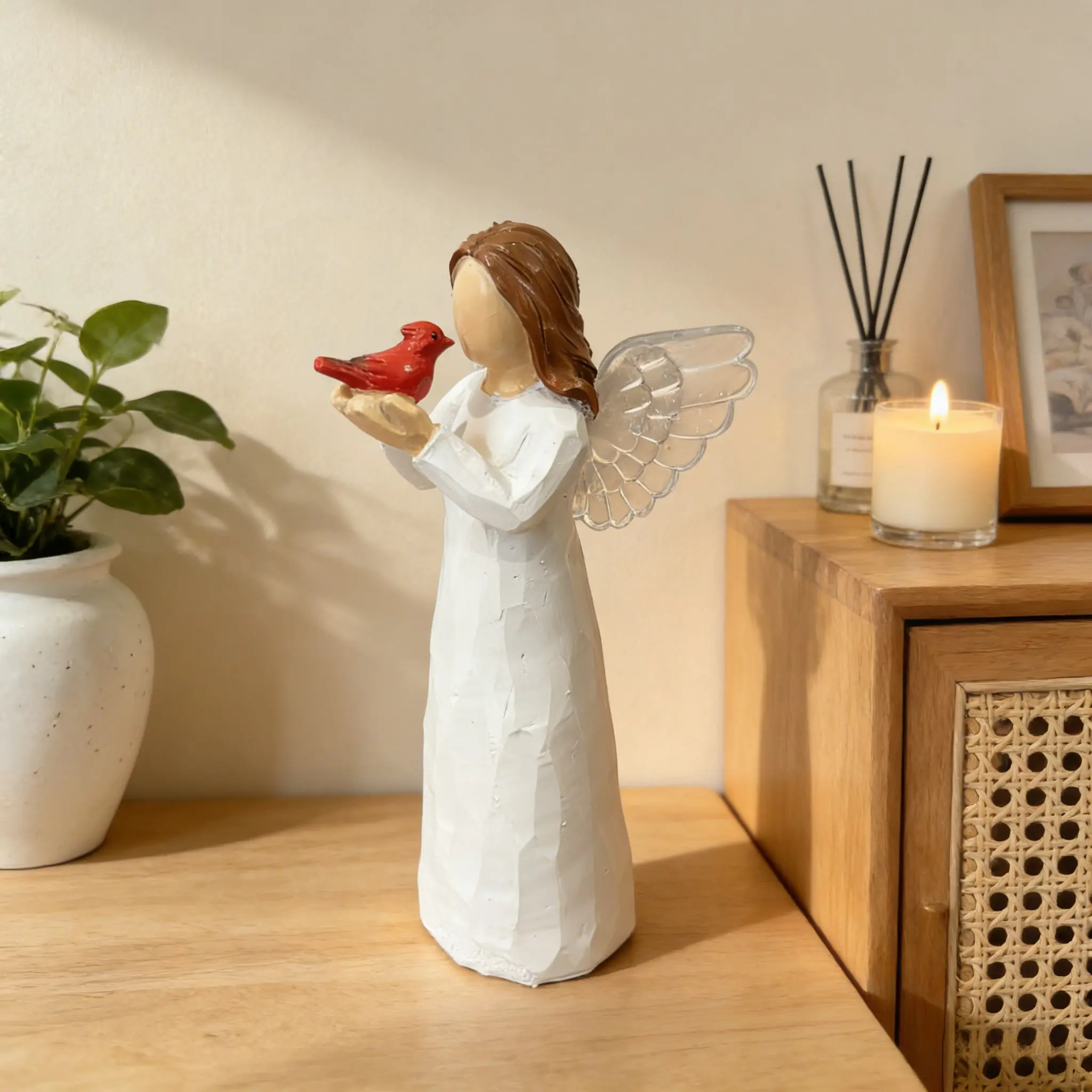 Graceful Angel with Cardinal Bird Resin Sculpture. Classic religious imagery for peaceful prayer room layout and shelf home styling. Sturdy resin structure, ideal present for devout believers and angel figurine collectors.