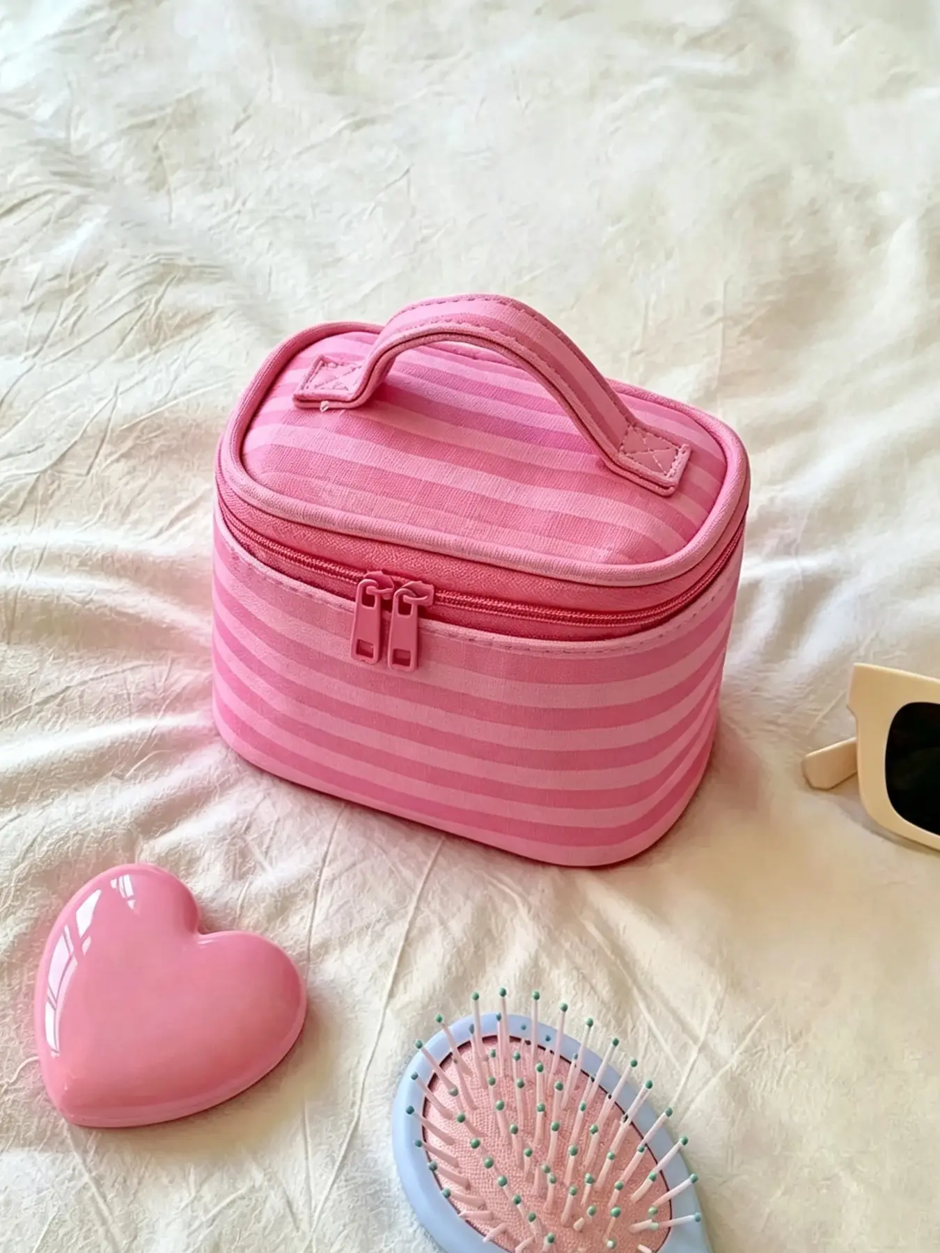 Pink‑striped makeup bag with built‑in mirror, zipper‑style travel cosmetic storage bag, portable organizer for beauty supplies and toiletries