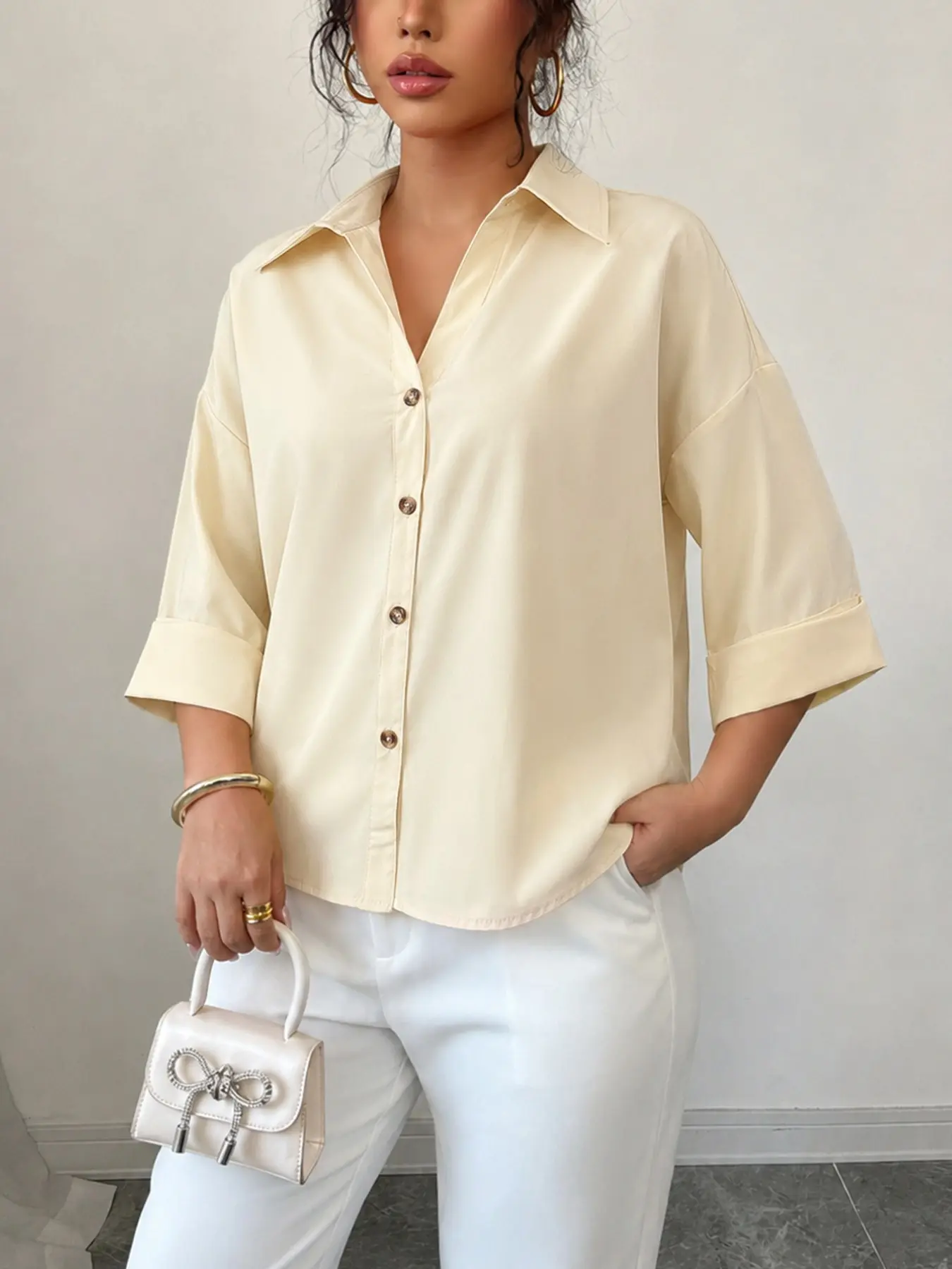 Relaxing milk yellow loose shoulder seven quarter sleeved shirt for women with V-neck rolled edge sleeves and a back slit design, a versatile Blouse Top for female office workers commuting, casual, leisure, going out for vacation, and looking slim