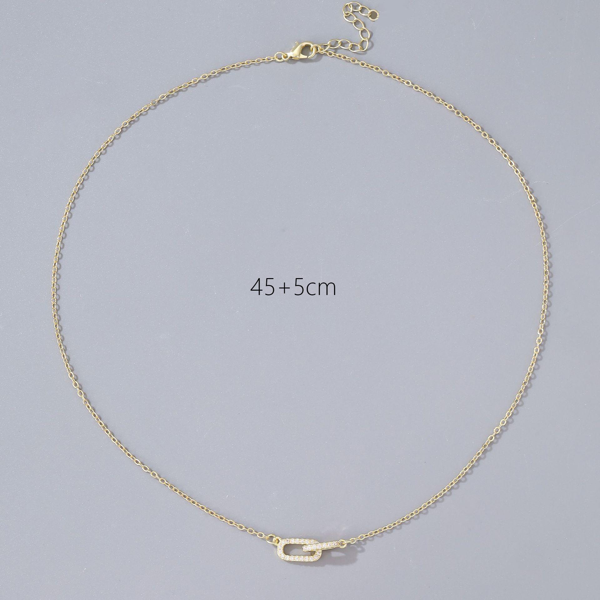 Oval necklace with interlocking double rings and diamond-encrusted pendant