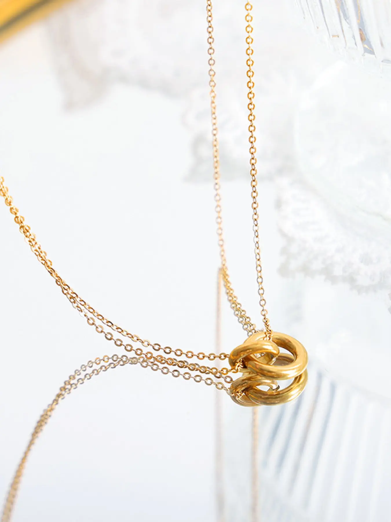 A fashionable gold interlocking double layered necklace, with a simple double ring pendant to create a high-end texture, suitable for various daily commuting, dating and other scenes, it is a versatile and elegant light jewelry item.