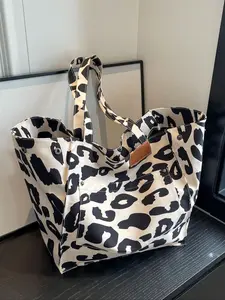 A versatile milk patterned tote bag with a fresh retro artistic style, featuring a side snap closure that tightens the bag opening. It is a simple, stylish, and large capacity textured shoulder bag that can accommodate tablets, documents