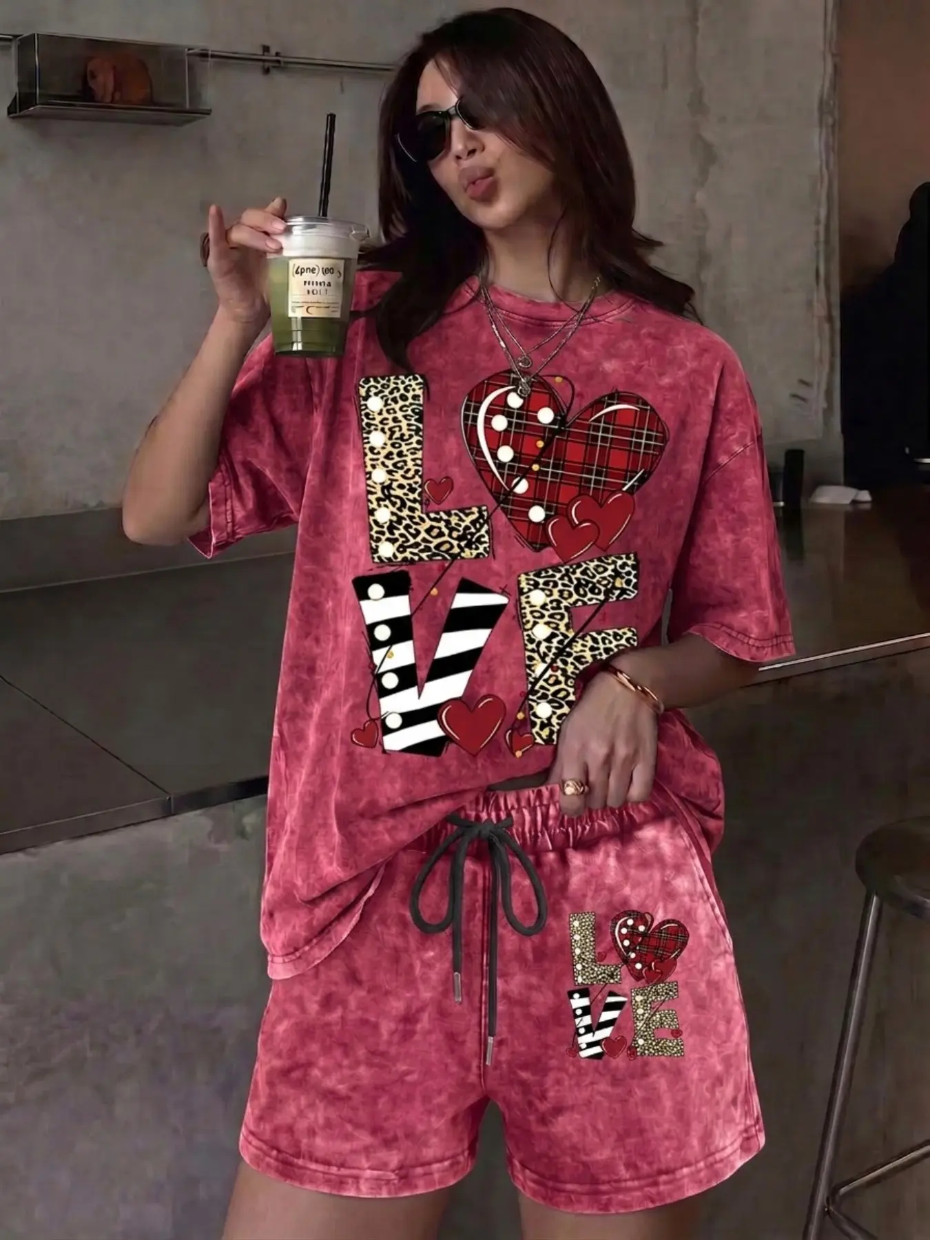 A street-style, Fashion, two-piece set featuring a vintage-wash and a mix of leopard and plaid prints forming a heart shape with "LOVE" lettering, suitable for outdoor leisure, the set includes a crew-neck, short-sleeved washed T-shirt and matching shorts