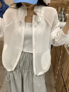 A fashionable white semi transparent texture drawstring stand up collar jacket for women, with lantern cuffs and long sleeves to cover the arms, suitable for commuting, indoor and outdoor wear
