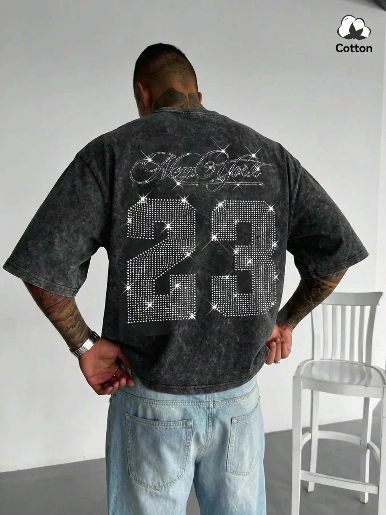 Men's washed, distressed cotton T-shirt featuring a boxy, cropped fit and a youthful crew-neck design; adorned with a "New York" rhinestone graphic, this piece embodies a street-style aesthetic suitable for casual daily wear or commuting.