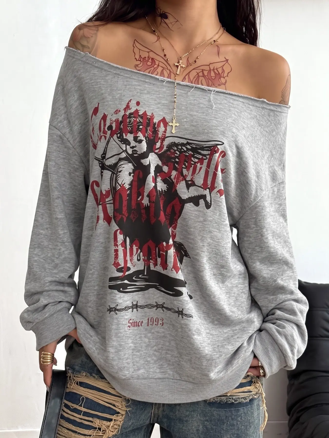 Women Grey Cupid Angel Print Off Shoulder Sweatshirt, Oversized Slash Neck Raw Trim Long Sleeve Pullover, Vintage Gothic Letter Graphic Loose Sweatshirt, Match Ripped Jeans For Co-ords Outfit, Casual Grunge Streetwear Top, Trendy Off Shoulder Sweatshirt F