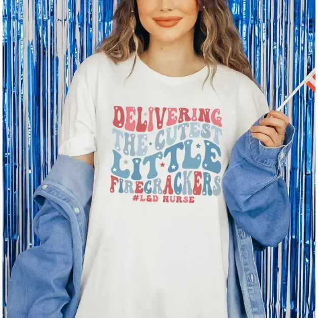Delivering The Cutest Little Firecrackers Graphic T‑Shirt, L&D Nurse Oversized Comfort Outfit, Fashion 4th Of July Cotton Tee, Perfect Holiday Gift For Her, Best Present For Nurse Lover Friend