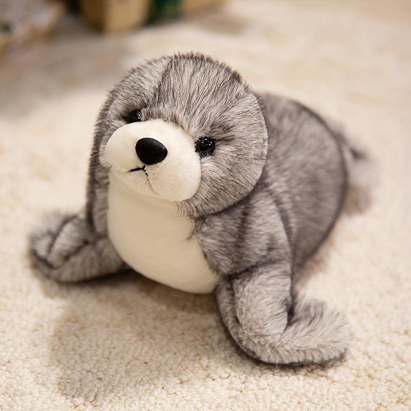 Adorable plush sea lion toy, super soft stuffed animal in a lazy pose, with silky fins suitable for cuddling and sensory play in the nursery