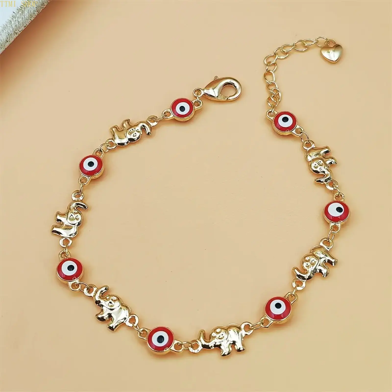 Bohemian Ethnic Elephant Charm Bracelet for Women, Gold Tone Adjustable Chain Animal Jewelry with Red Eye Detail