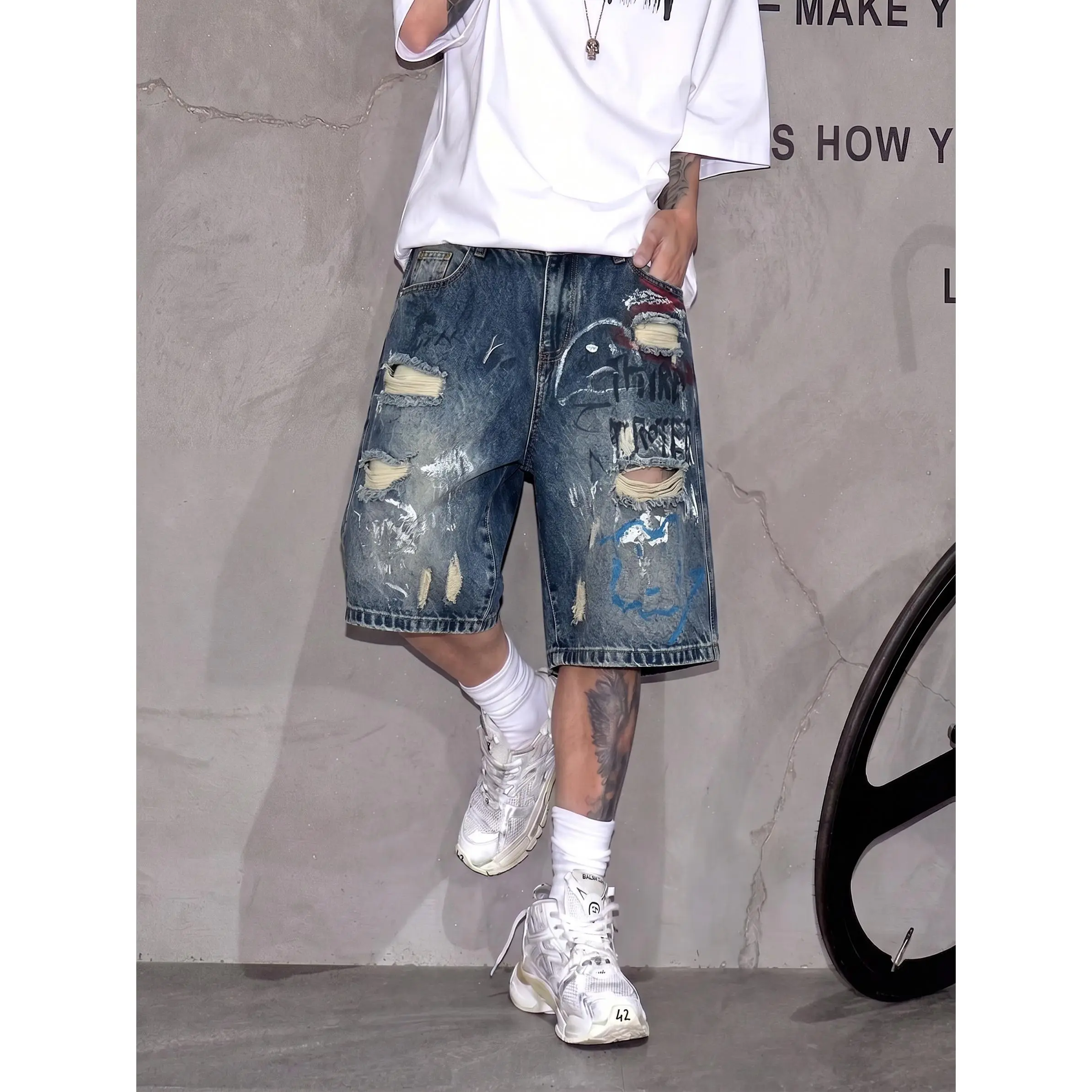Men's dark washed graffiti splatter distressed loose denim shorts, knee-length distressed street style denim shorts, vintage washed hand-painted graffiti denim shorts, printed street style denim shorts.