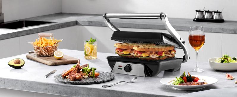 SUSTEAS Compact Indoor Grill – Features a non-stick surface, 180° adjustable lid for even heat distribution, and space-saving foldable design. Perfect for meats, veggies, and quick meals.