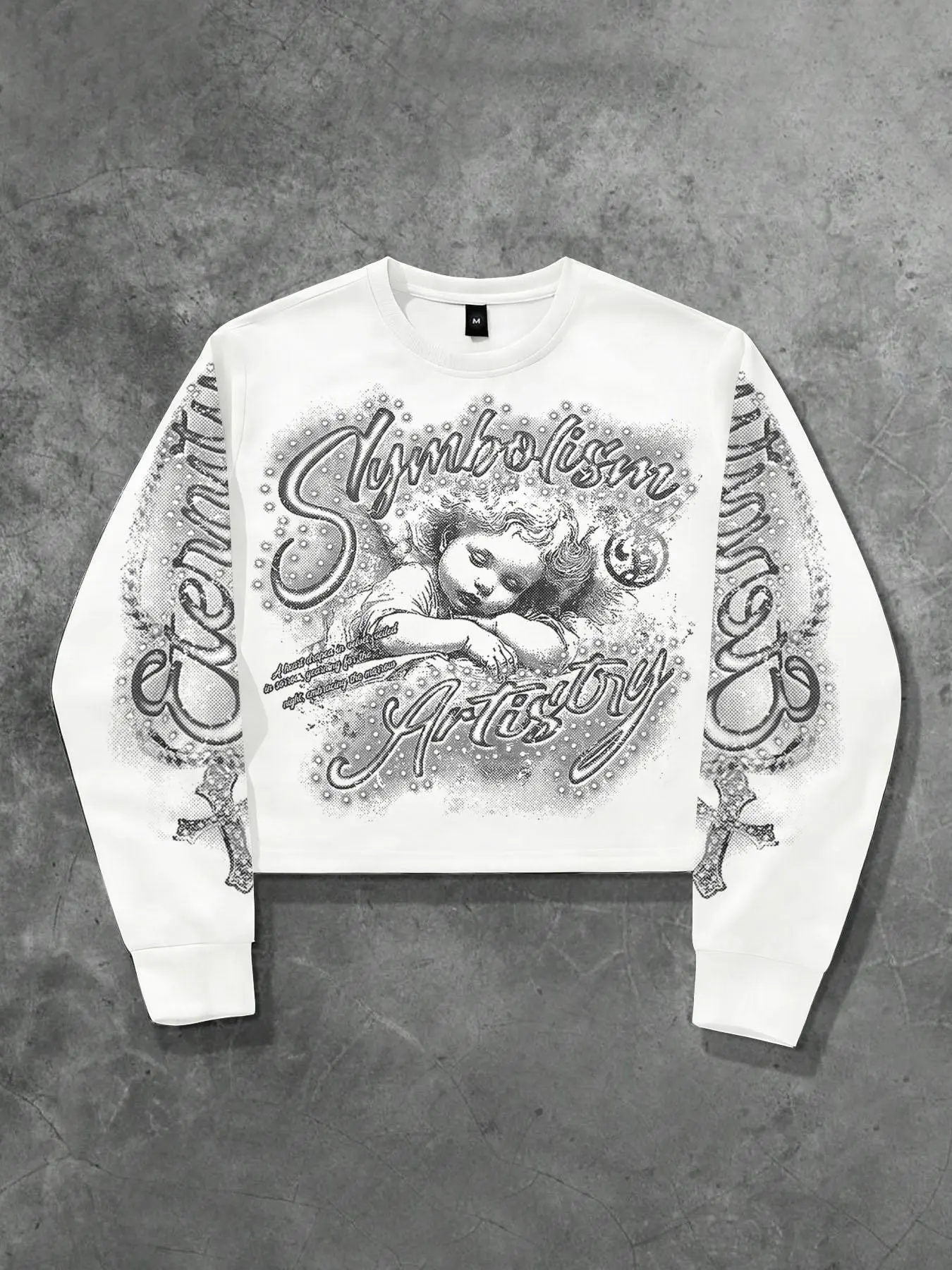 Retro white cropped long-sleeve sweatshirt featuring an all-over print on the sleeves and a Y2K-style black-and-white "sleeping cherub" graphic; a versatile, casual, streetwear-inspired long-sleeve top.