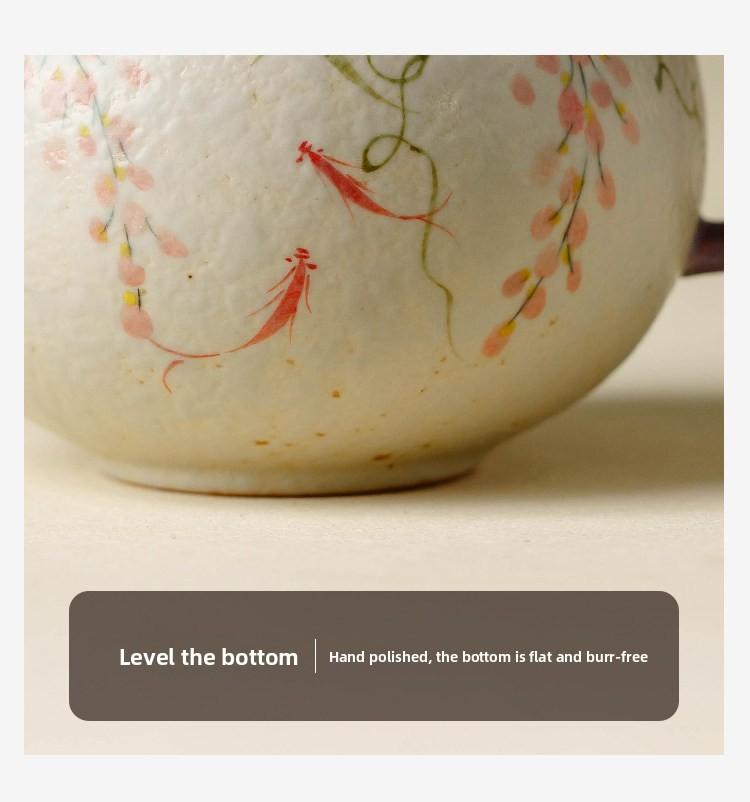 The hand-painted wisteria and carp pattern coffee cup, crafted by artisans, is an attractive and practical ceramic tea cup with a vintage style and vibrant colors