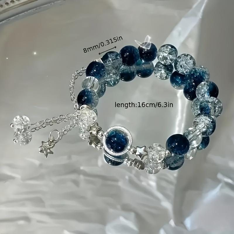An elegant glass bead bracelet featuring a star pendant-a sophisticated, faux cat's-eye style accessory suitable for women and individuals aged 15 and up. Perfect for Valentine's Day, Carnival, and Christmas parties.