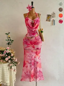 A vacation-style tie-dye floral print maxi dress with a draped halter neck, featuring sheer mesh and metal buckle details. Ideal for beach getaways, tropical trips and summer parties. Women