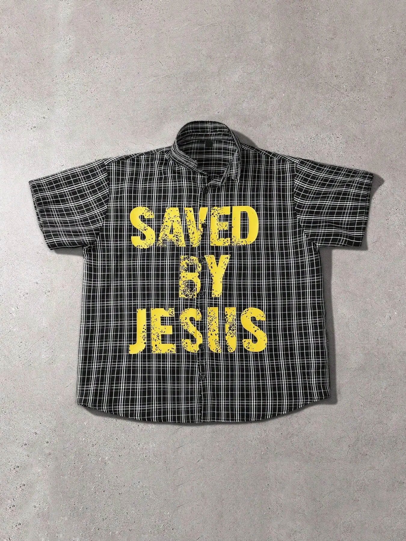 This men's retro classic plaid short-sleeved button-down shirt features a distressed "Saved By Jesus" design, making it a casual and relaxed streetwear shirt.