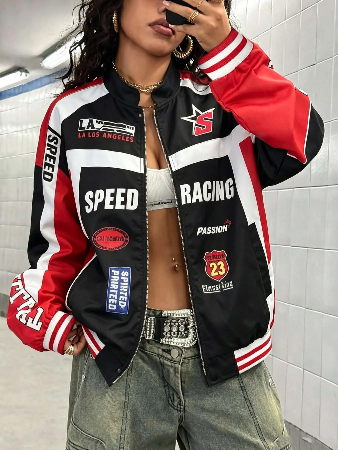 Unisex black and red color-block racing bomber jacket with multiple patches and letter prints, zip-up style, made from lightweight and comfy fabric. Perfect for streetwear, skateboarding, music festivals, and casual hangouts.