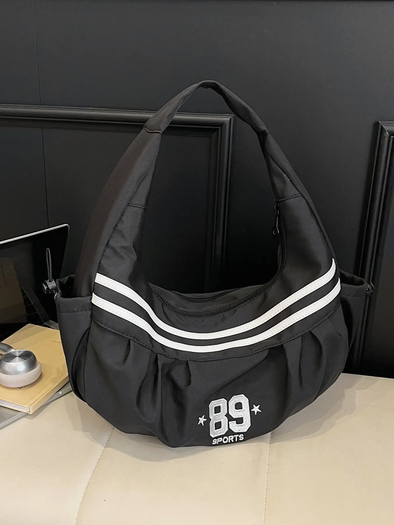 Simple and casual unisex shoulder bag with drawstring side pockets, lightweight and spacious for daily commute and outdoor activities - tote bag.