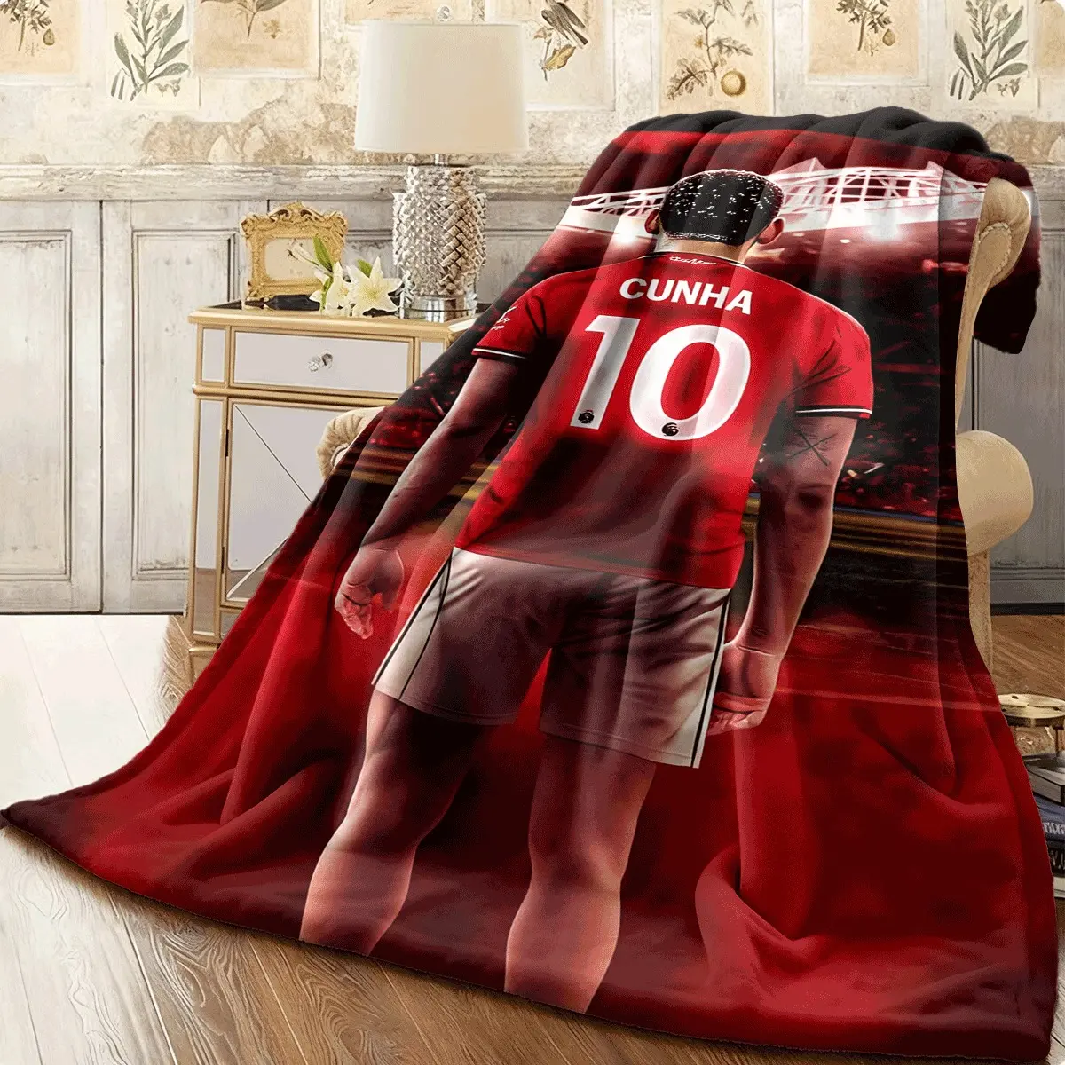 This 10th anniversary stadium flannel blanket for football players features a vibrant red and black team crest design and is made of lightweight, warm material. It's suitable for home, office, and travel, making it the perfect gift for football fans and p