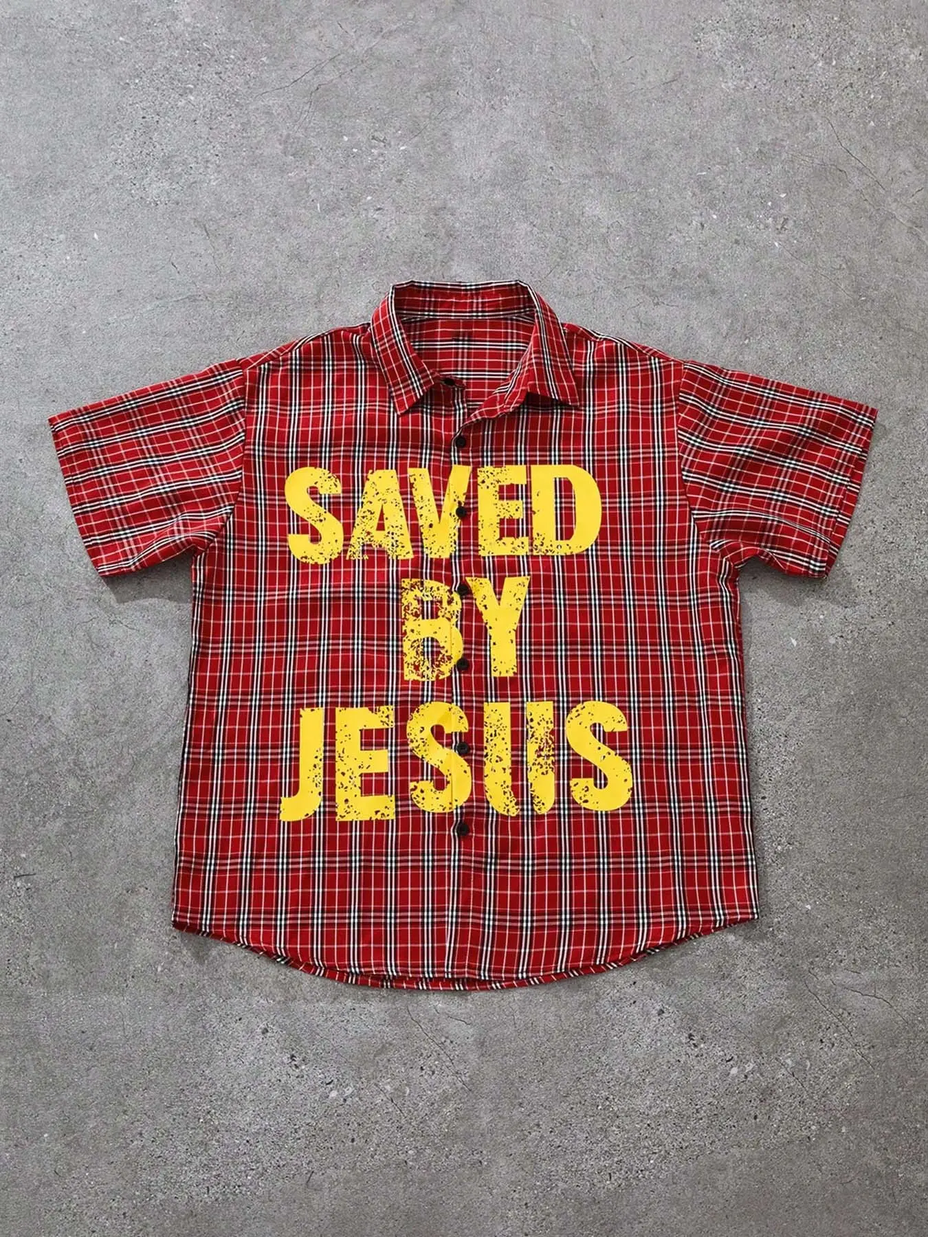 Men's red plaid short-sleeve shirt, street-style Graphic 'SAVED BY JESUS' with bold yellow letters, Christian streetwear top, made of soft and comfortable fabric, suitable for church gatherings, casual family outings, and hanging out with friends.