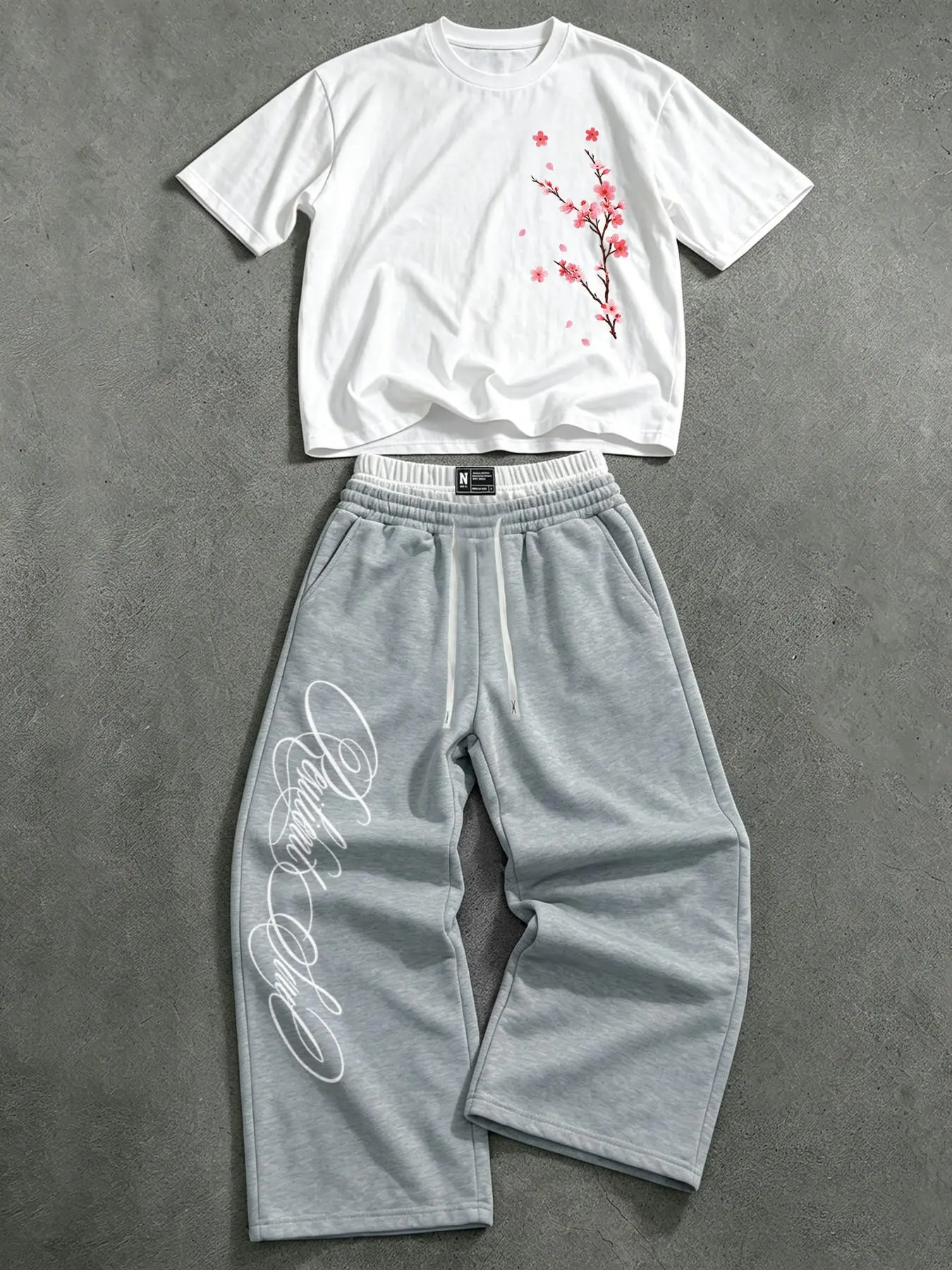 Men's two-piece casual suit: a short-sleeved T-shirt with a cherry blossom pattern and wide-leg sweatpants; a casual street style tracksuit.