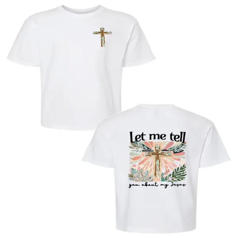 Colorful Graphic Black T-Shirt for Girls - Features Floral Cross Design and Inspirational 'Let me tell you about my Jesus' Text |   Adorned with Pink Hair Clips, Perfect for Casual Wear |   Stylish and Eye-Catching Top for Young Fashionistas
